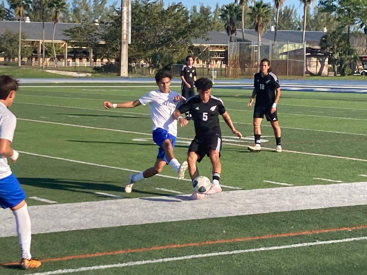 Cypress Bay defender Bautista Briones (5) battles Ferguson’s Antonio Triana for a loose ball during Tuesday’s Region 4-7A quarterfinal at Tropical Park.