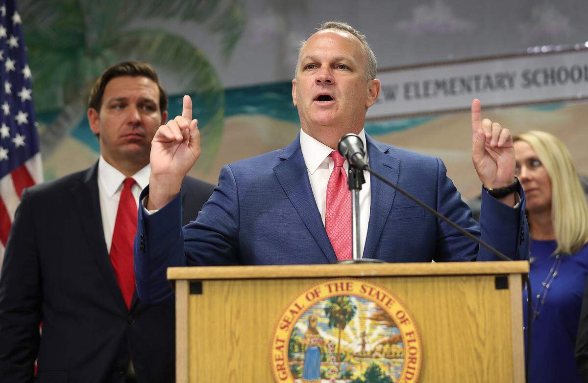 Florida Education Commissioner Richard Corcoran speaks during a press conference at Bayview Elementary School in Fort Lauderdale Monday where he and Gov. Ron DeSantis, left, announced a plan to raise the minimum starting salary for teachers.