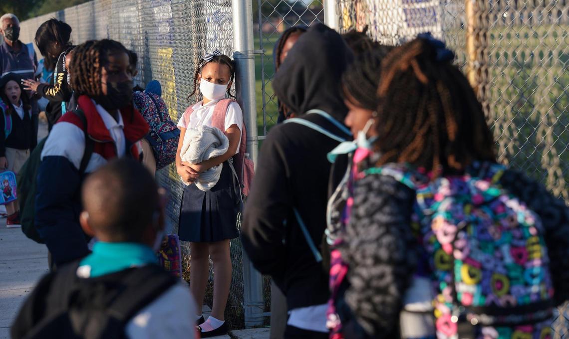 Parents of Pre-K to fifth grade students wait to be let into school as parents arrived early with their children at Miami Gardens Elementary School in Miami Gardens, Florida, on Wednesday, Aug. 17, 2022.