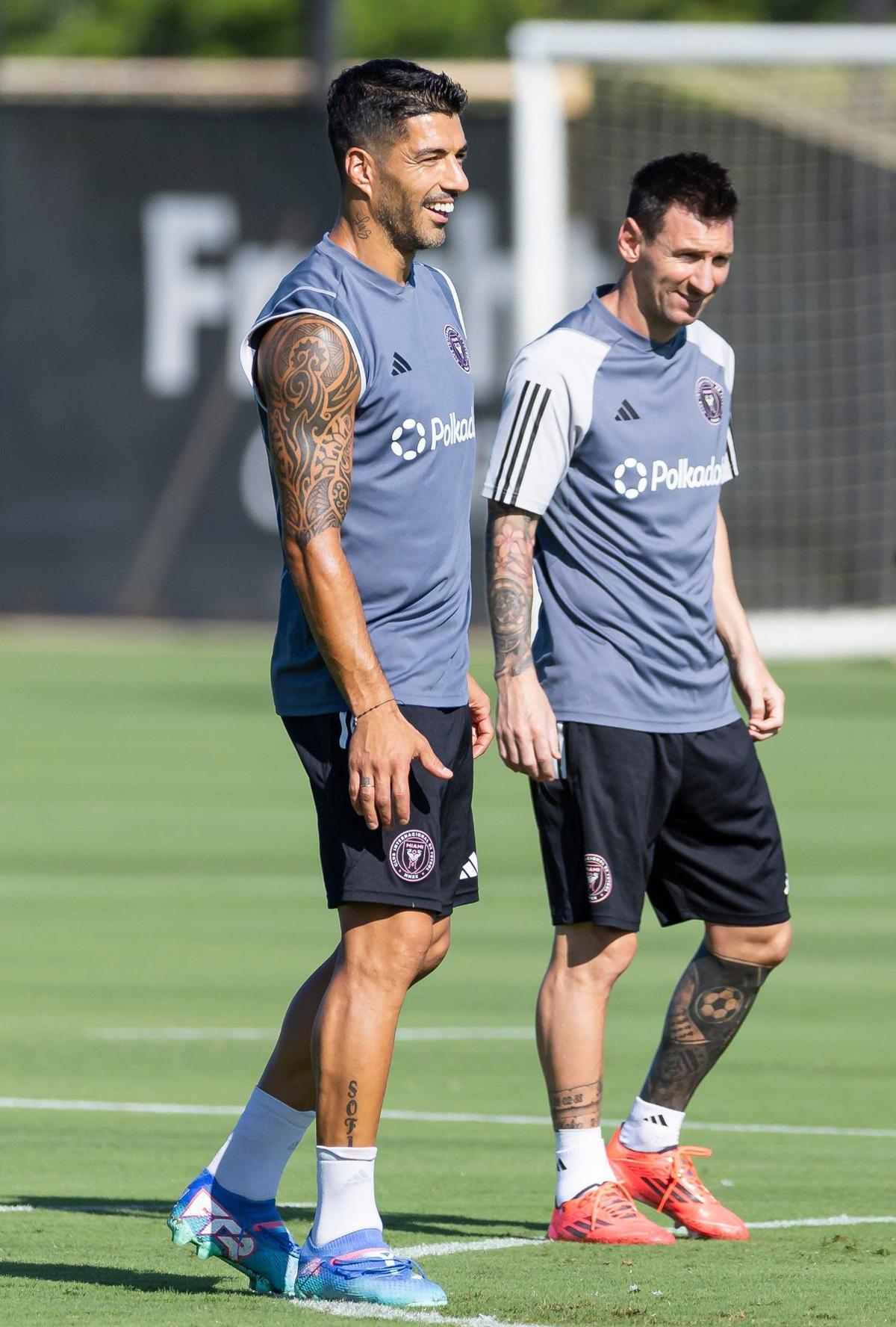 Inter Miami forwards Luis Suárez (9) and Lionel Messi (10) react during a team practice session at the Florida Blue Training Center on Friday, Sept. 13, 2024, in Fort Lauderdale, Fla.