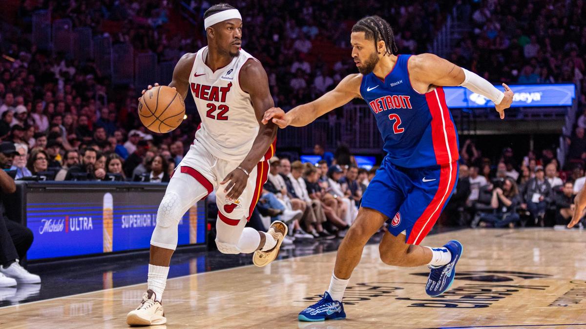 Miami Heat forward Jimmy Butler (22) dribbles past Detroit Pistons guard Cade Cunningham (2) during the second quarter of an NBA game at Kaseya Center on October 28, 2024, in Miami.