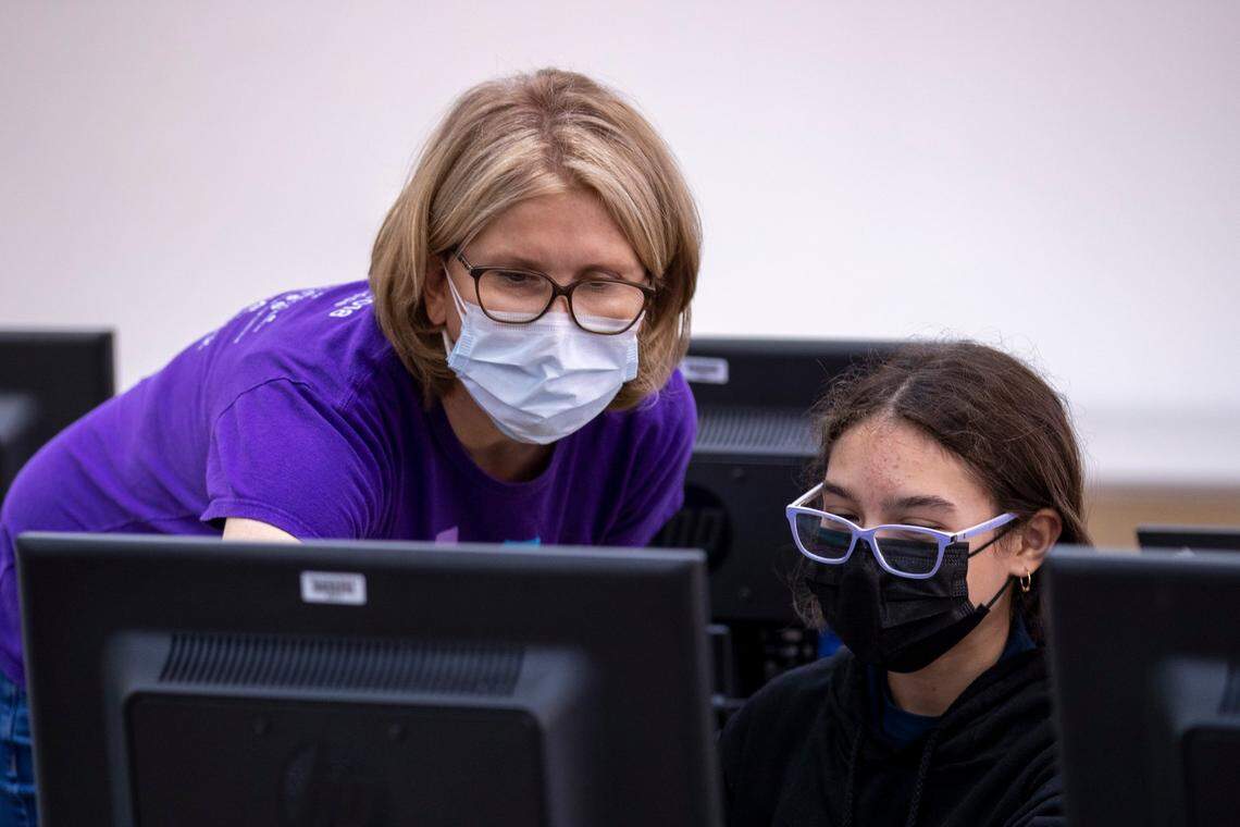 Amy Renshaw, CEO and Co-Founder of Code/Art, a successful nonprofit that teaches coding skills to young girls, looks at the work of Luna Gutierrez, 12, during a lesson at their office on 550 NW 42nd Ave. in Miami on Monday, Oct. 4, 2021.