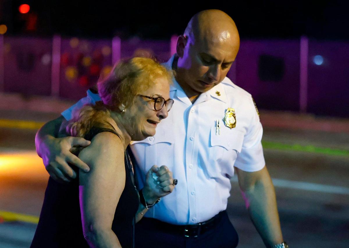 Miami Dade Fire Rescue Chief Raied Jadallah consoles Kerry Billedeau after lighting the torch to honor those who died during the collapse of the Champlain Towers South in Surfside. The Second Annual Remembrance Ceremony was held at 1:22 AM at Veterans Park across from the site of the collapse on Saturday, June 24, 2023.