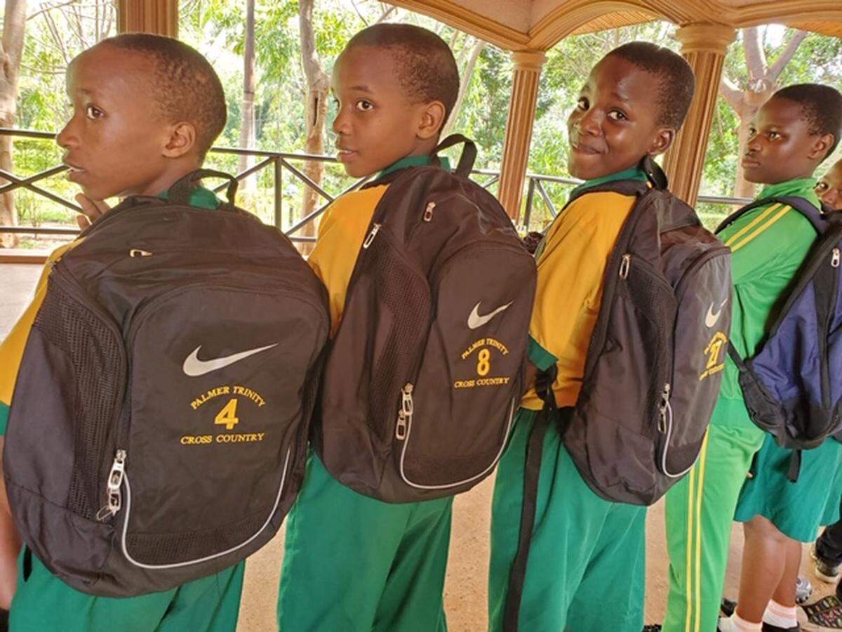 Haruna, Sagi, Athumani and Diana sport their new school backpacks donated by Afrikids, a non-profit organization that also operates a school club at Palmer Trinity School.
