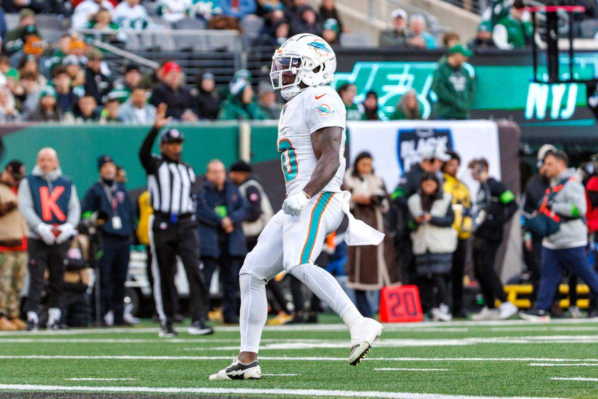 Miami Dolphins wide receiver Tyreek Hill (10) reacts running for a first down during first quarter of an NFL football game against the New York Jets at MetLife Stadium on Friday, Nov. 24, 2023 in East Rutherford, New Jersey.