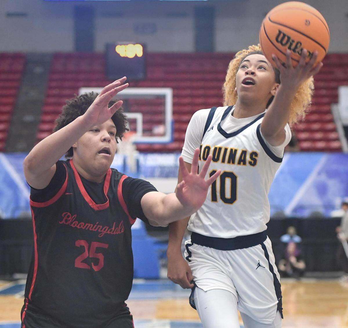St. Thomas Aquinas’ Khadee Hession (10) shoots against Bloomingdale’s Izellah Kendrick (25) in the Class 6A final during the Florida High School State Championships at the RP Funding Center in Lakeland, Fl on Friday March 8, 2024. Hession scored 16 points. St. Thomas defeated Bloomingdale 70-35. Scott Wheeler | Photo