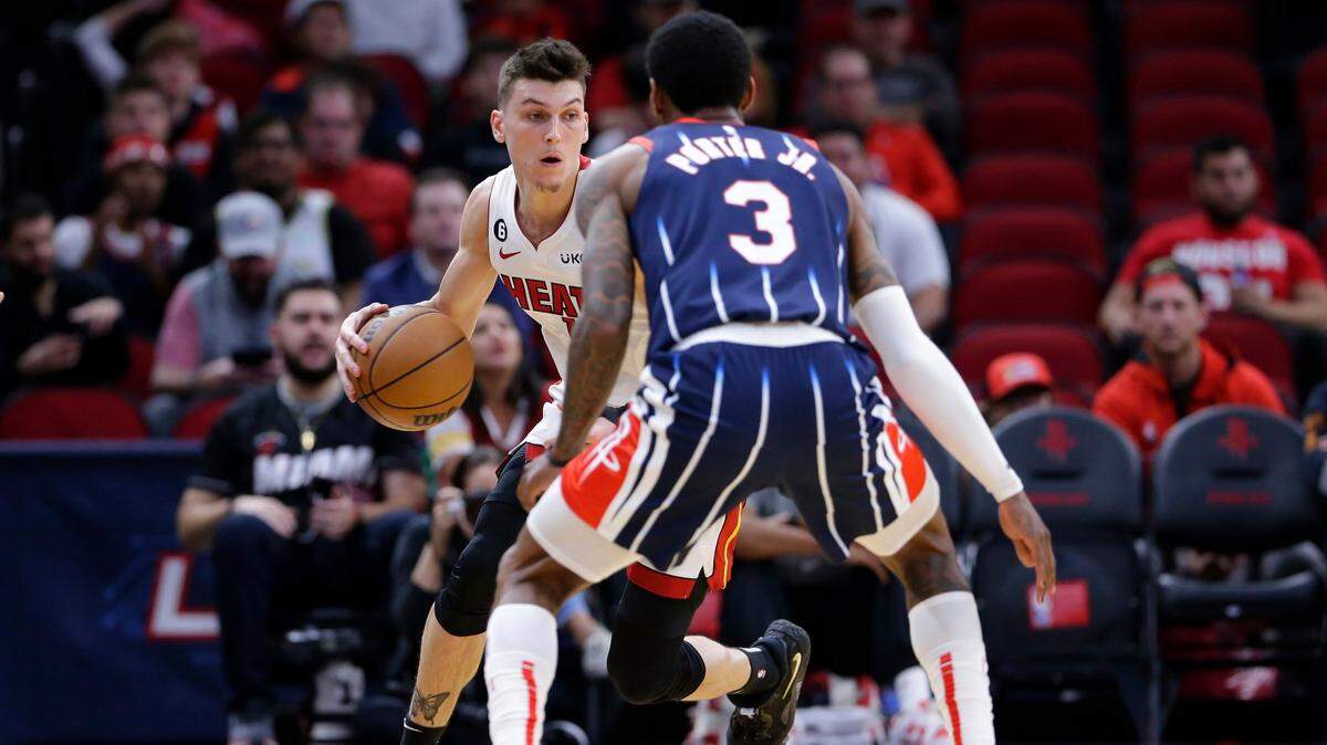 Miami Heat guard Tyler Herro, left, looks to drive around Houston Rockets guard Kevin Porter Jr. (3) during the first half of an NBA basketball game Thursday, Dec. 15, 2022, in Houston.