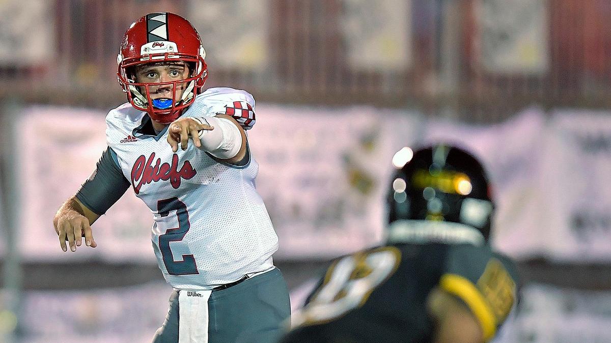 Cardinal Gibbons quarterback Nik Scalzo wants a blocker on American Heritage’s Timothy Butler during the first half of their game, Friday, October 12, 2018.