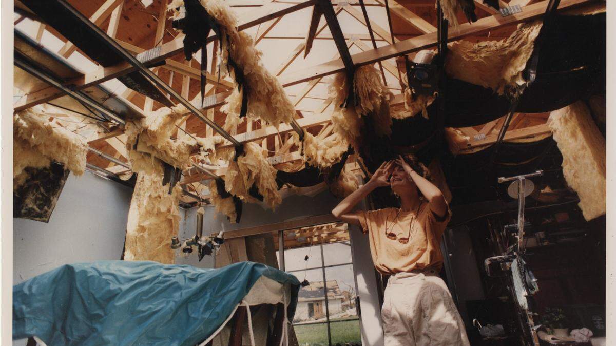 In this August 1992 photo from the Miami Herald-published book about Hurricane Andrew, “The Big One,” South Miami-Dade resident Sharon Hench looks up at the huge holes in the roof of her Country Walk home. During the storm, she and her husband, Michael, dashed from room to room to survive.