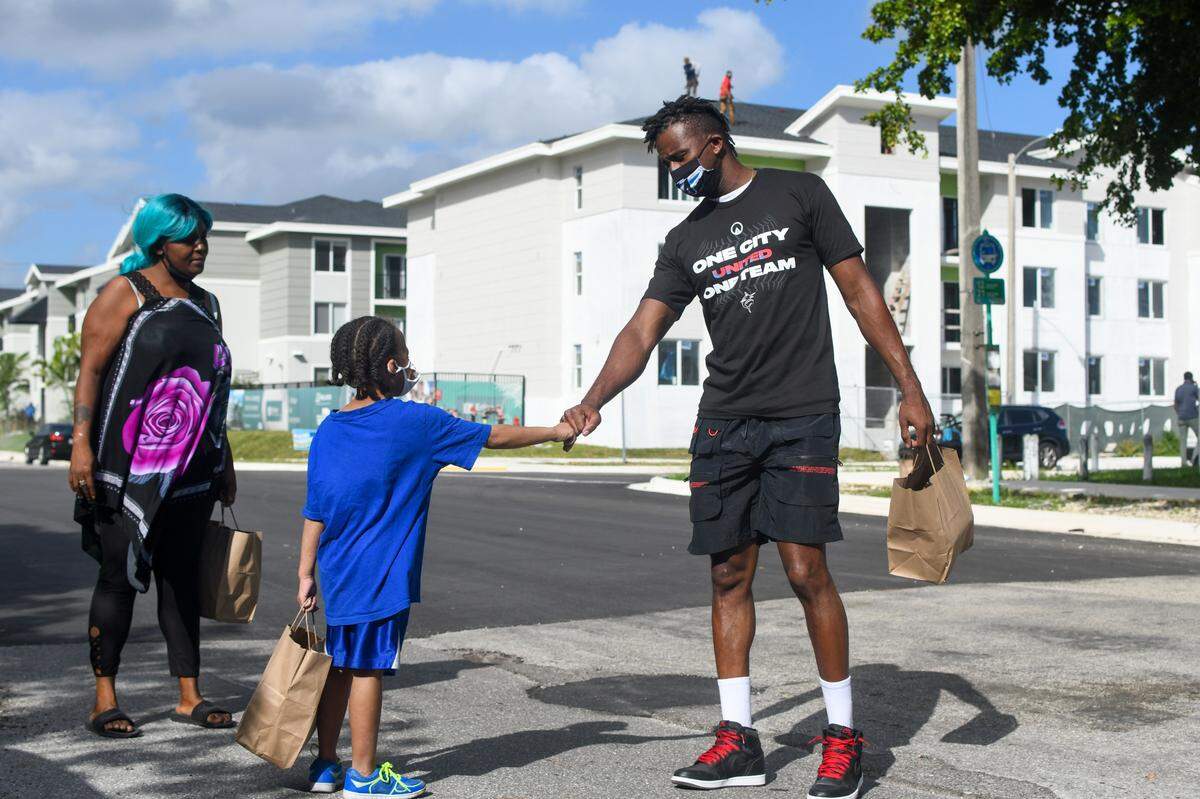 Miami Marlins outfielder Lewis Brinson gives out free meals at the Liberty Square Community Center polling station in Liberty City on Tuesday, Nov. 3, 2020.