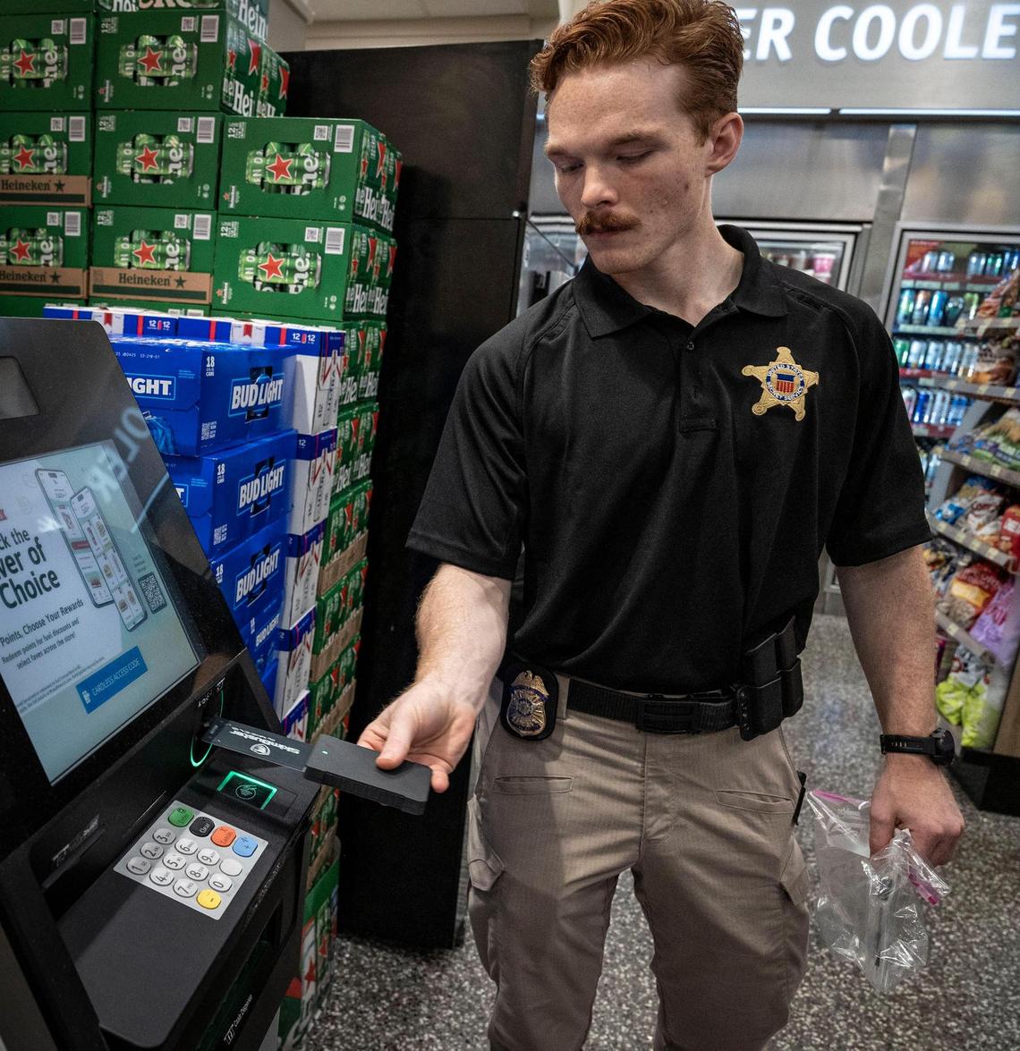 Miami, FL, July 23, 2025 - U.S. Secret Service Agent uses a Skim Buster to detect the presence of a Credit Card Skimming device in a card reader inside a business in Hialeah, Florida. The Secret Service is conducting an operation in Miami this week aimed at combatting EBT fraud and illegal ATM point-of-sale payment card skimming. They will be going around to different businesses and informing them about the scams.
