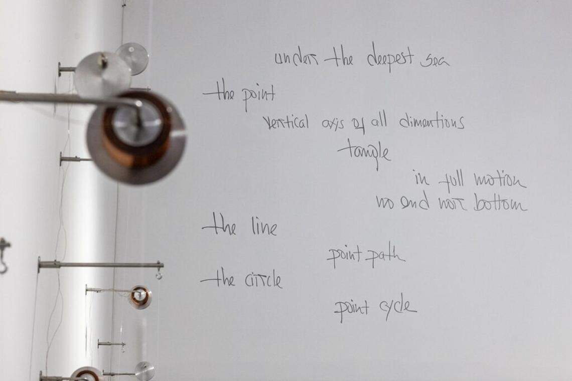 A handwritten poem in English and Spanish is on one of the walls of Alba Triana’s installation.