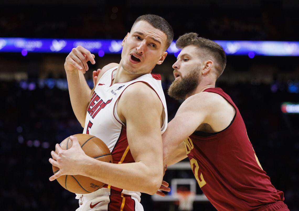 Miami Heat forward Nikola Jovic (5) is guarded by Cleveland Cavaliers forward Dean Wade (32) during the second half of a game on Nov. 10, 2025, at Kaseya Center in Miami.