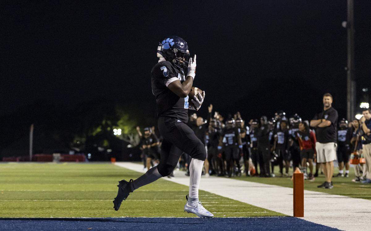 Palmetto Panthers running back Aiden Butler (2) scores a touchdown against the Columbus Explorers in the first half of their Region 4-7A quarterfinal high school football playoff game at Tropical Park on Friday, Nov. 21, 2025, in Miami, Fla.
