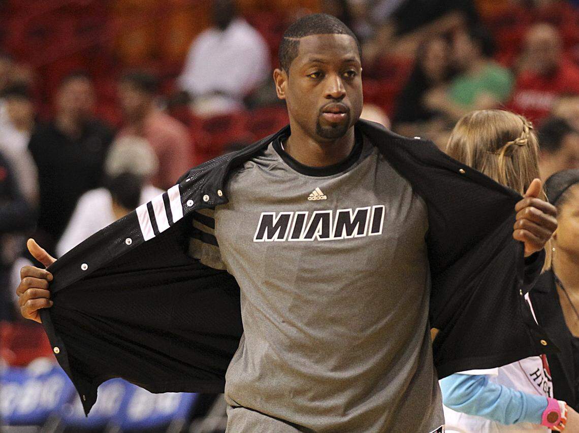 The Miami Heat’s Dwyane Wade takes off his jacket as the team prepares to play the Boston Celtics at AmericanAirlines Arena in Miami, Florida, April 10, 2012.