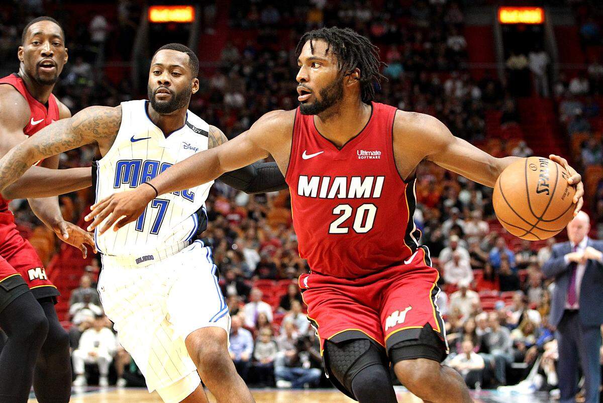 Heat forward Justise Winslow drives to the basket against Magic’s forward Jonathon Simmons in the first quarter of the Miami Heat vs Orlando Magic at AmericanAirlines Arena in Miami on Tuesday, December 04, 2018.