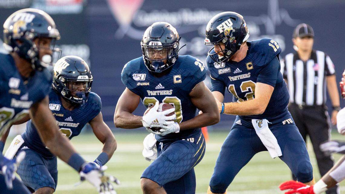 Florida International University starting quarterback James Morgan (12) hands the ball off to runningback Napoleon Maxwell (23) during the first quarter of the the season opener against Western Kentucky at Riccardo Silva Stadium in Miami, Florida on Saturday, September 7, 2019.