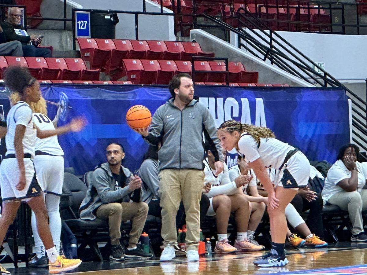 St. Thomas Aquinas coach Oliver Berens catches a ball that went out of bounds on Thursday during the Raiders’ 62-35 win over Wekiva in a Class 6A girls basketball state semifinal at the RP Funding Center in Lakeland, Fla.