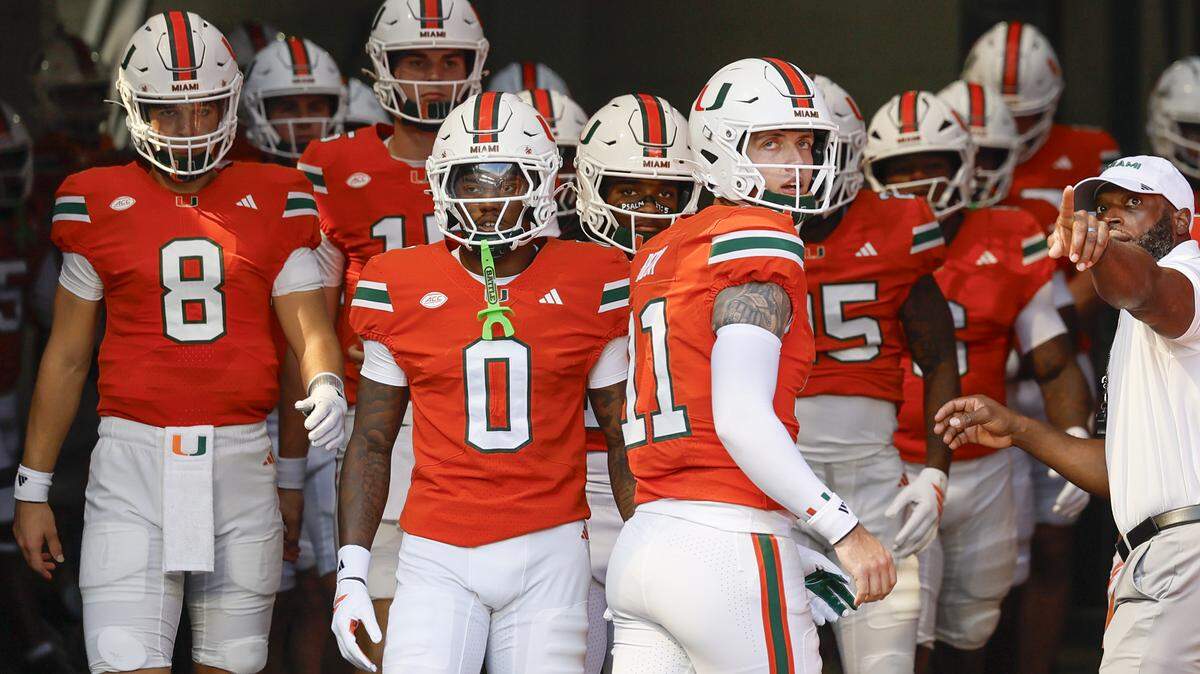 Miami Hurricanes quarterback Carson Beck (11) leads the team out of the tunnel for warmups before the start of their NCAA football game against the South Florida Bulls at Hard Rock Stadium in Miami Gardens, Florida, on Saturday, September 13, 2025.