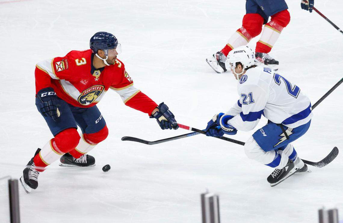 Florida Panthers defenseman Seth Jones (3) tries to get the puck from Tampa Bay Lightning center Brayden Point (21) during the second period of a game on Monday, March 3, 2025, at Amerant Bank Arena in Sunrise, Fla.