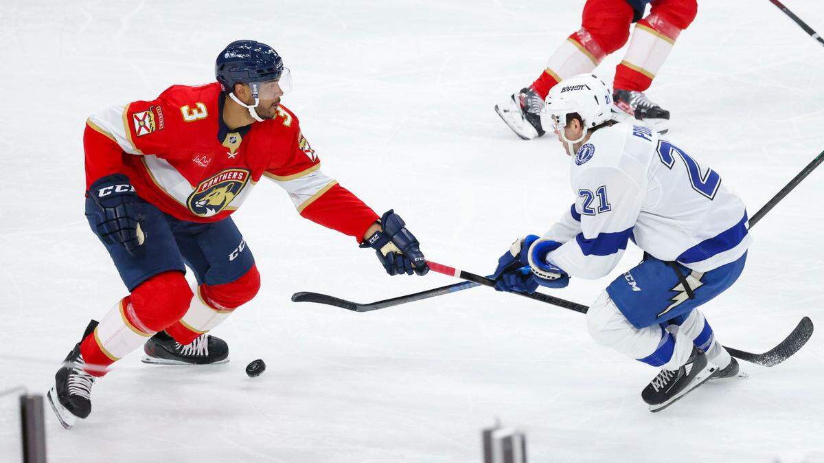 Florida Panthers defenseman Seth Jones (3) tries to get the puck from Tampa Bay Lightning center Brayden Point (21) during the second period of a game on Monday, March 3, 2025, at Amerant Bank Arena in Sunrise, Fla.