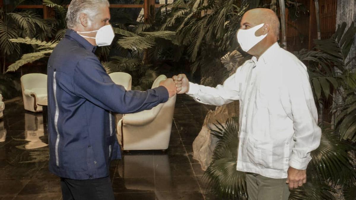 The Cuban leader Miguel Díaz-Canel greets Cuban American activist Carlos Lazo, during a meeting at the Palace of the Revolution in Havana, on August 25, 2021.