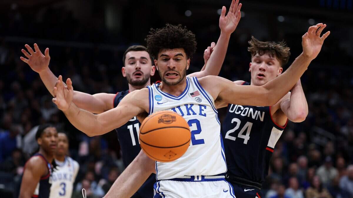 WASHINGTON, DC - MARCH 29: Cameron Boozer #12 of the Duke Blue Devils and Braylon Mullins #24 of the UConn Huskies battle for the ball during the first half of a game in the Elite Eight of the 2026 NCAA Men's Basketball Tournament at Capital One Arena on March 29, 2026 in Washington, DC. (Photo by Patrick Smith/Getty Images)