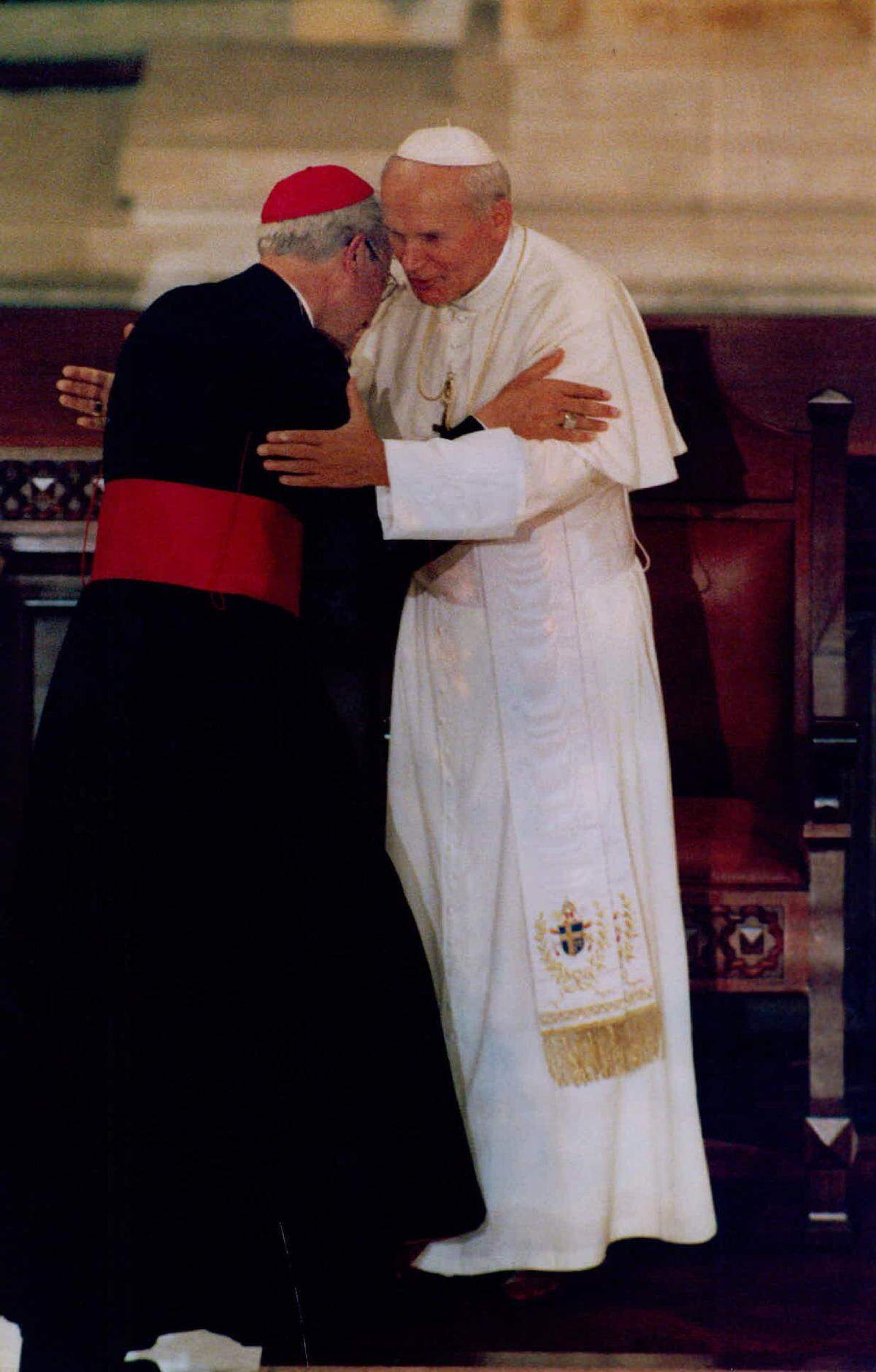 Archbishop of Miami Edward McCarthy embraces Pope John Paul II at St. Mary’s Cathedral.