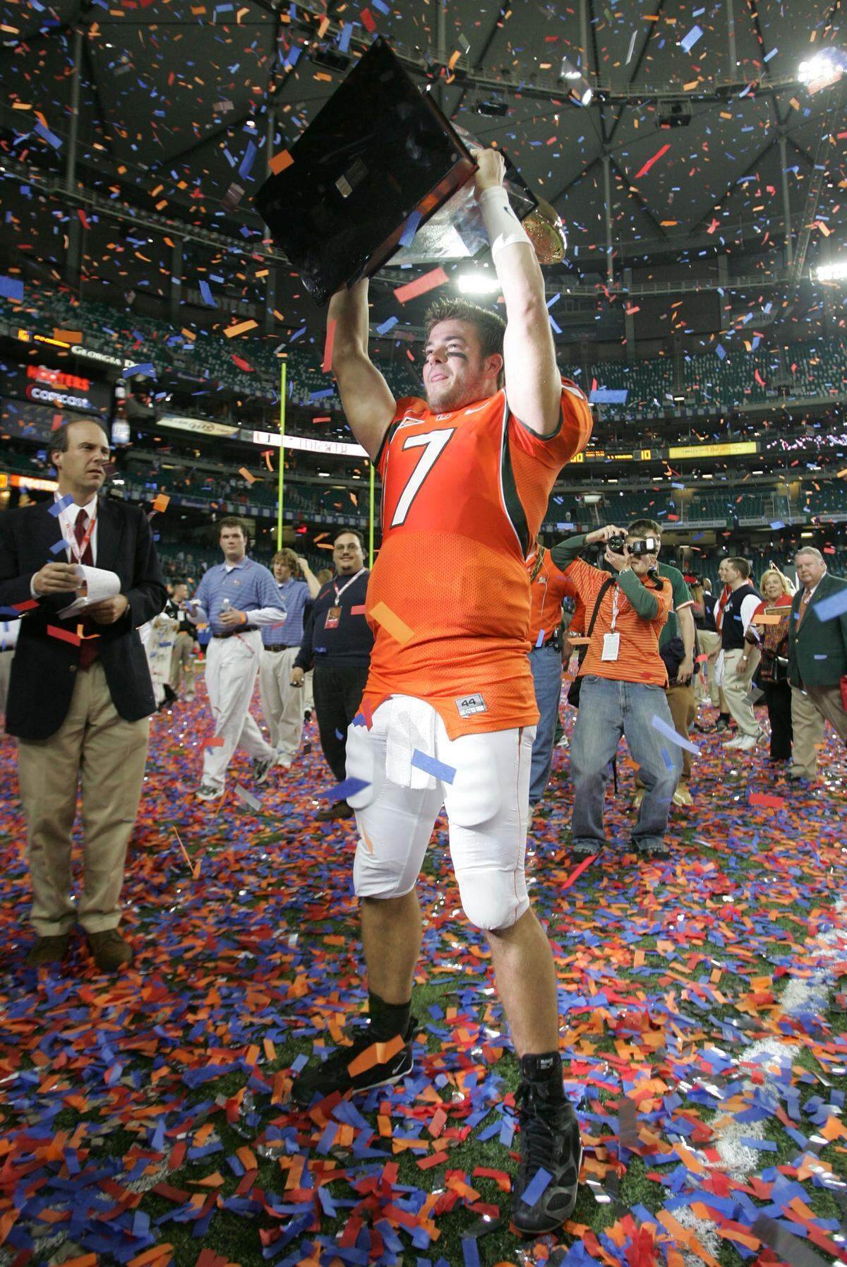 Canes quarterback Brock Berlin hoists the Peach Bowl trophy in 2004 after UM defeated the UF Gators.