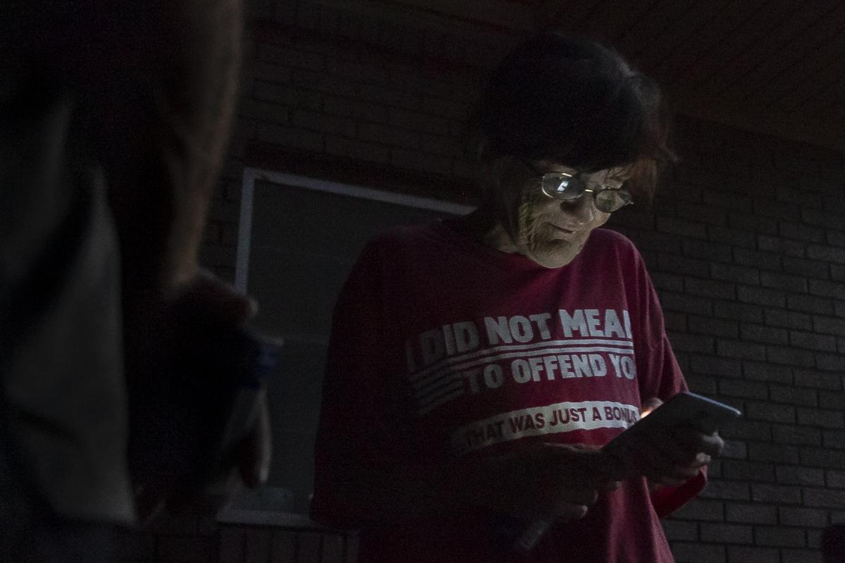 Lorraine DePriest, 55, who suffers from many medical issues, uses her cellphone near her former home in a public housing complex in Panama City, Florida, on Friday, Oct. 19, 2018. Hurricane Michael devastated the Florida Panhandle leaving tens of thousands without food, power or shelter.