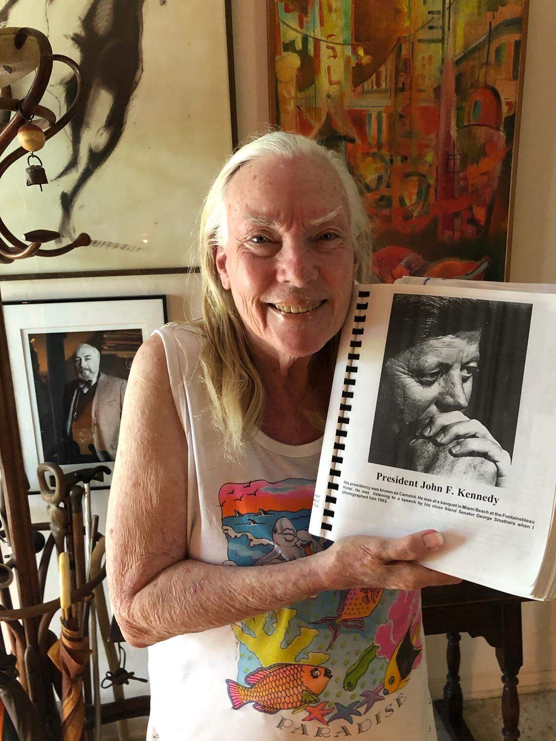 Suzanne Fisher, 86, holds her favorite portrait by her husband, Ray Fisher, a black-and-white picture of  President John F. Kennedy that he captured in 1962 at the Fontainebleau Hotel in Miami Beach.&nbsp;