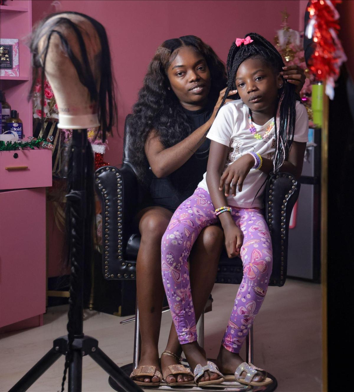 Hairstylist Jamecia Grandoit, 27, left, and her daughter Promise Jean, 7, right, were photographed at her salon called “The Doll Squad” in Lauderhill.