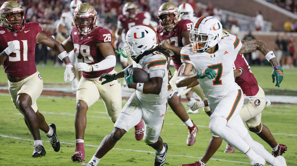 Miami Hurricanes wide receiver Malachi Toney (10) on a pass reception as wide receiver CJ Daniels (7) attempts to clear a path from Florida State Seminoles defenders in the first half at Doak Campbell Stadium in Tallahassee, Florida, on Saturday, October 4, 2025.