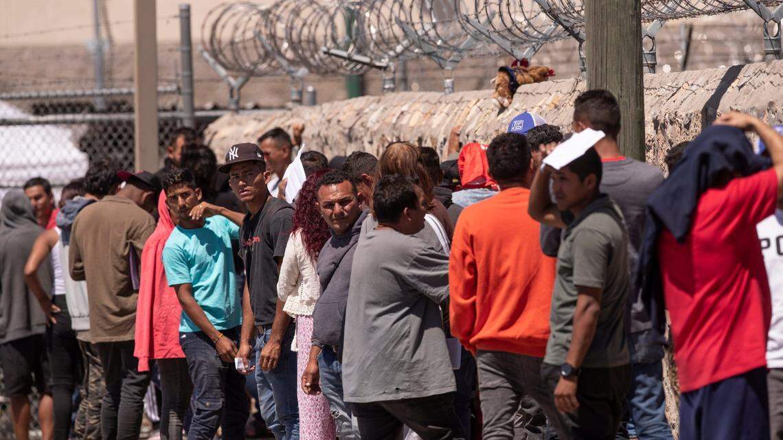 Migrants line up to turn themselves in to Customs and Border Protection in El Paso, Texas on Tuesday, May 9, 2023.