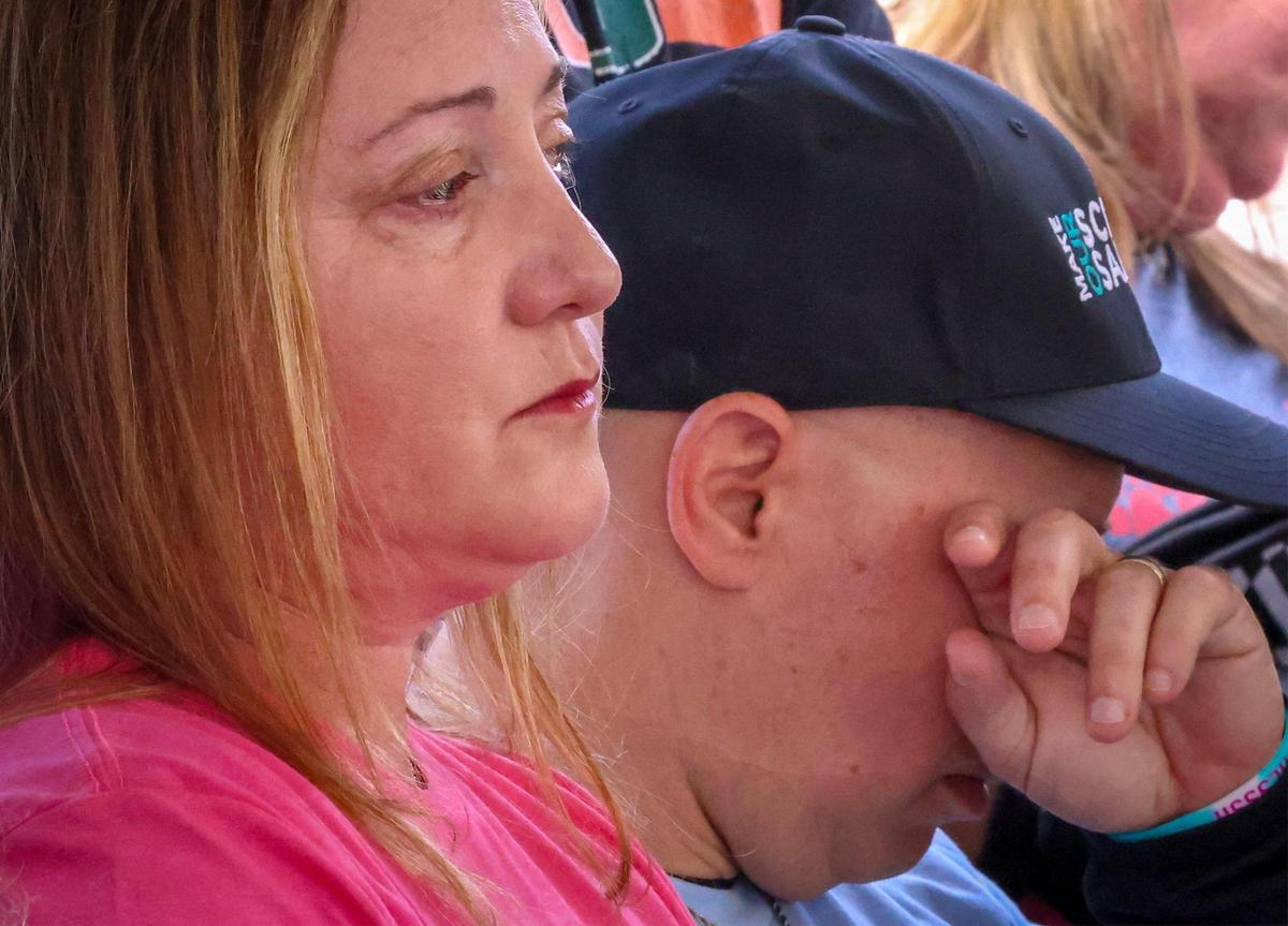 Lori Alhadeff, left, and husband Ilan Alhadeff, right, sit in contemplation after lighting a candle in remembrance of the victims of the shooting at Margaret Stoneman Douglas in 2018. The Alhadeff’s lost their daughter in the shooting.