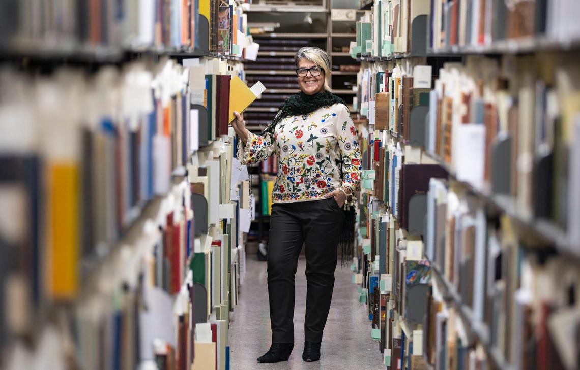 Cristina Favretto, head of special collections at the University of Miami libraries, stands amid some of the thousands of rare, historic and unusual books, manuscripts, documents and volumes of ephemera held in the archive. The books are available for inspection to the public.