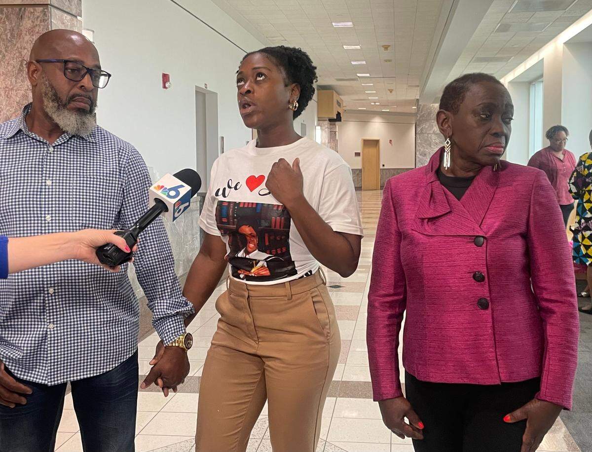 Shola Henry, center, speaks to reporters joined by her father Steve Henry, left, and mother Sylvia Henry, right. The Henry family was present in a Broward County courtroom Friday, Nov. 8, 2024, for the sentencing of the man convicted of killing 22-year-old Stepha Henry in 2007 in Broward.