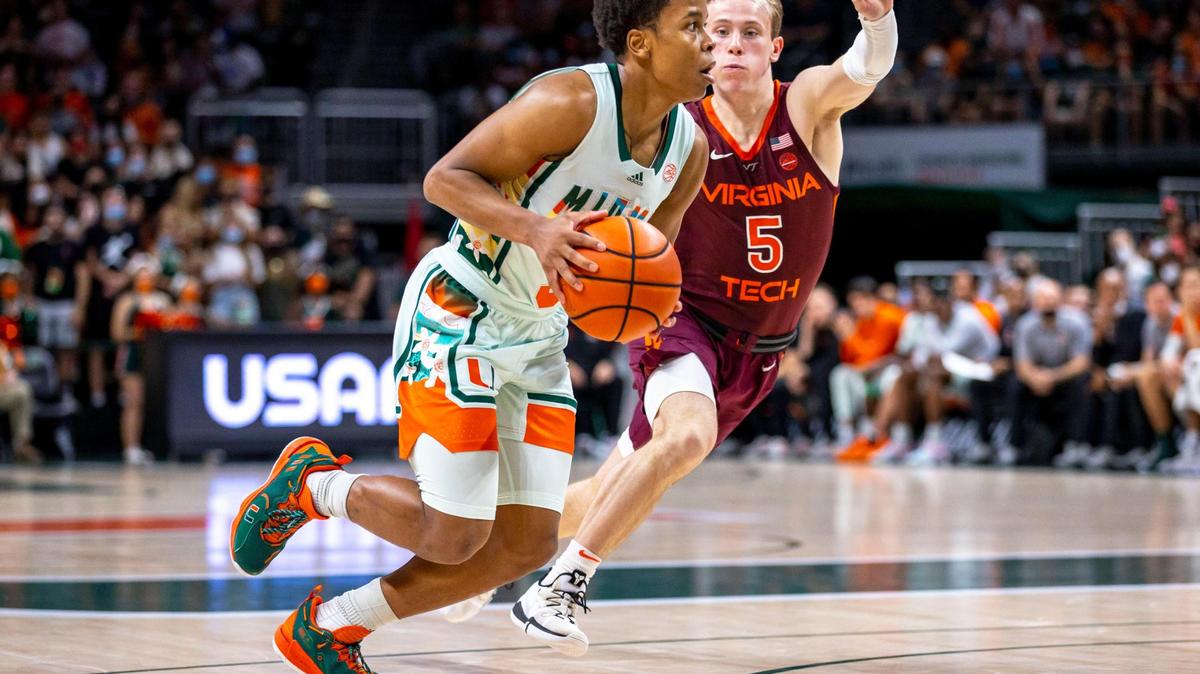 University of Miami guard Charlie Moore (3) dribbles past Virginia Tech guard Storm Murphy (5) during the first half of an NCAA basketball game at the Watsco Center in Coral Gables, Florida, on Saturday, February 26, 2022.