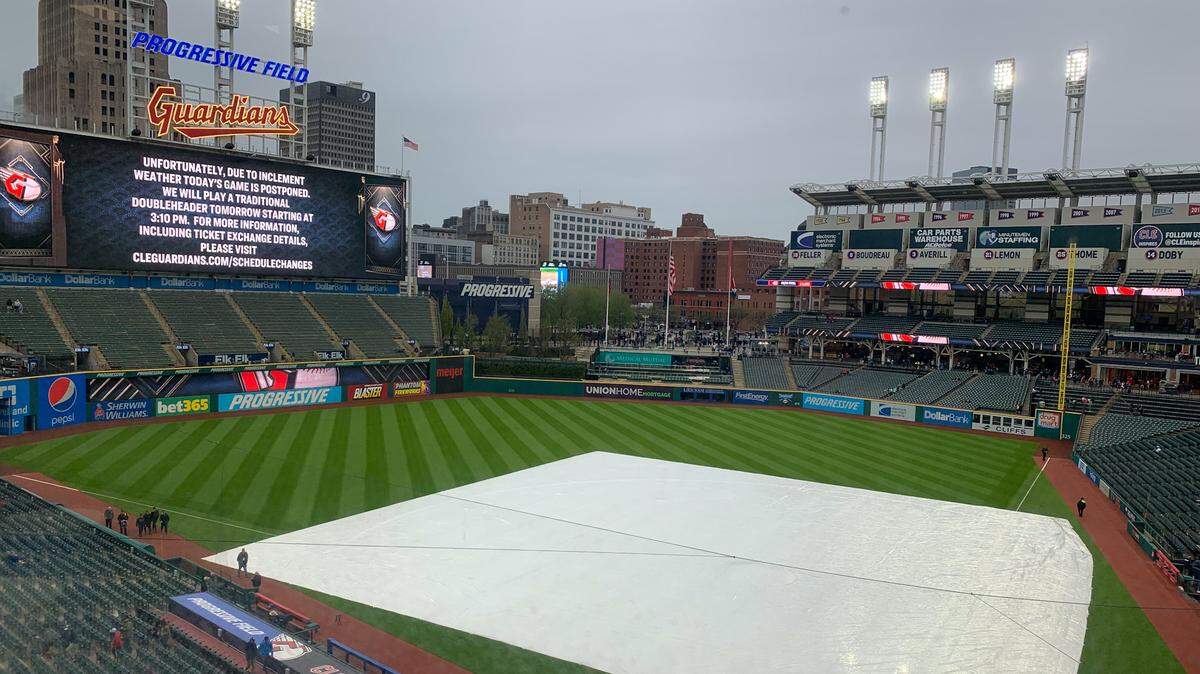 A tarp lies on the Progressive Field infield on Friday, April 21, 2023. The Miami Marlins’ series opener against the Cleveland Guardians was postponed due to inclement weather.
