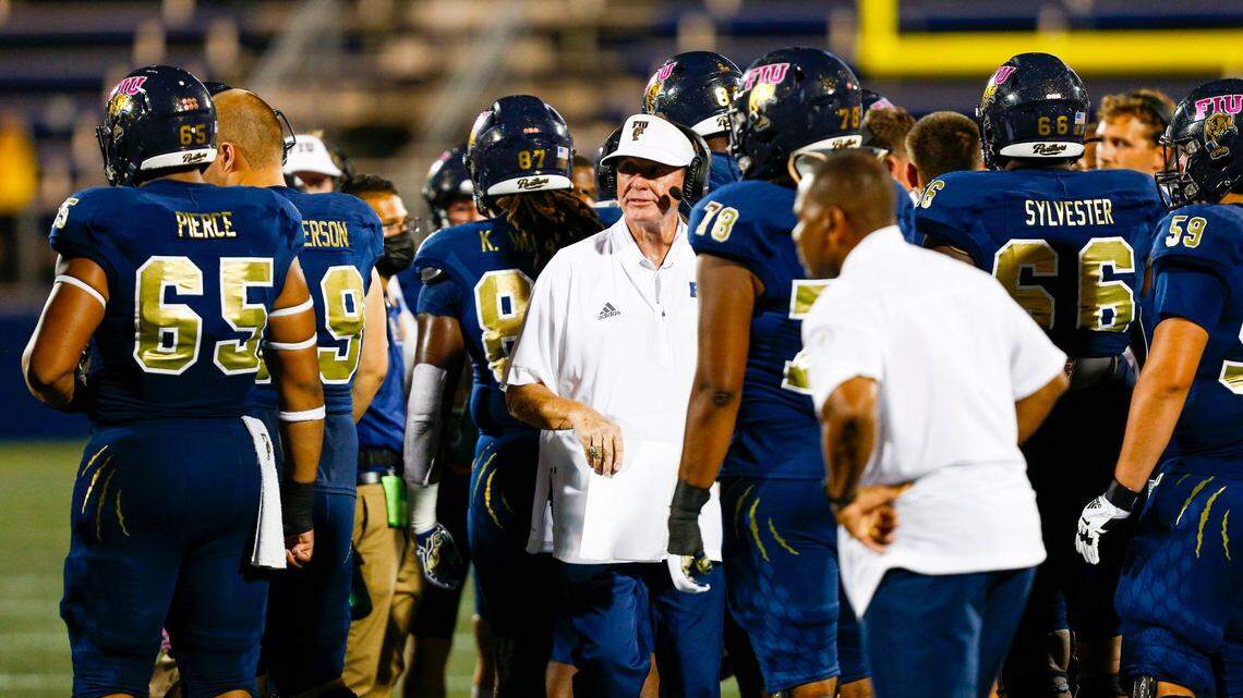 Florida International University Head Coach Butch Davis speaks to his players during the first quarter of an NCAA Conference USA football game against University of North Carolina at Charlotte 49ers at Riccardo Silva Stadium in Miami, Florida, on Friday, October 8, 2021.