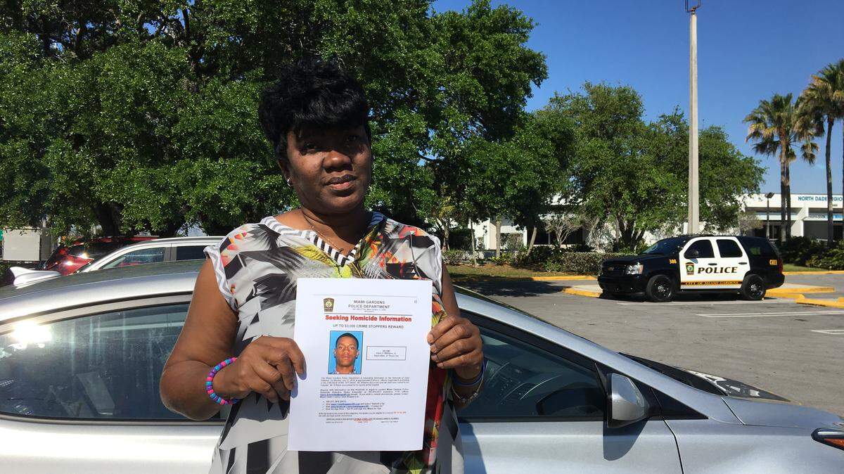 Samantha McDaniel, the mother of homicide victim Darin Williams, holds a flyer seeking information on her son’s July 2018 shooting on Saturday, March 23, 2019. McDaniels and a band of volunteers passed the flyers out in the Miami Gardens neighborhood where the shooting happened.