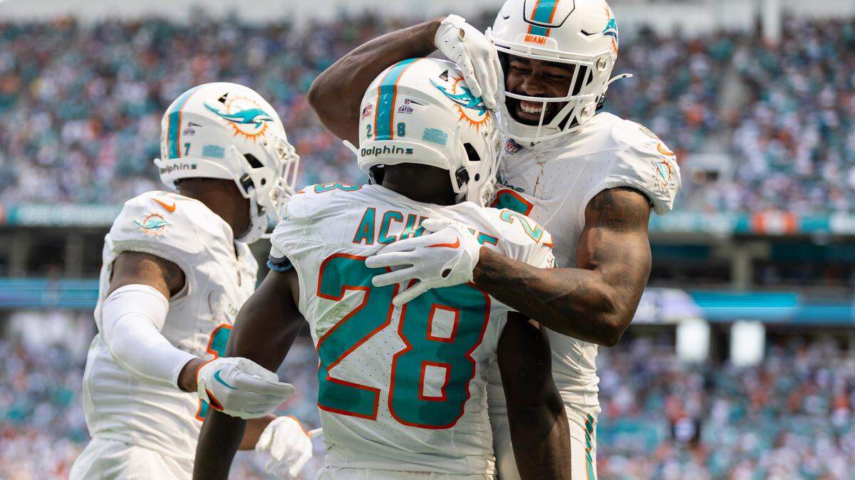 Miami Dolphins running back De’Von Achane (28) celebrates with running back Raheem Mostert (31) after scoring a touchdown against the New York Giants in the second quarter of an NFL game at Hard Rock Stadium on Sunday, Oct. 8, 2023, in Miami Gardens, Fla.