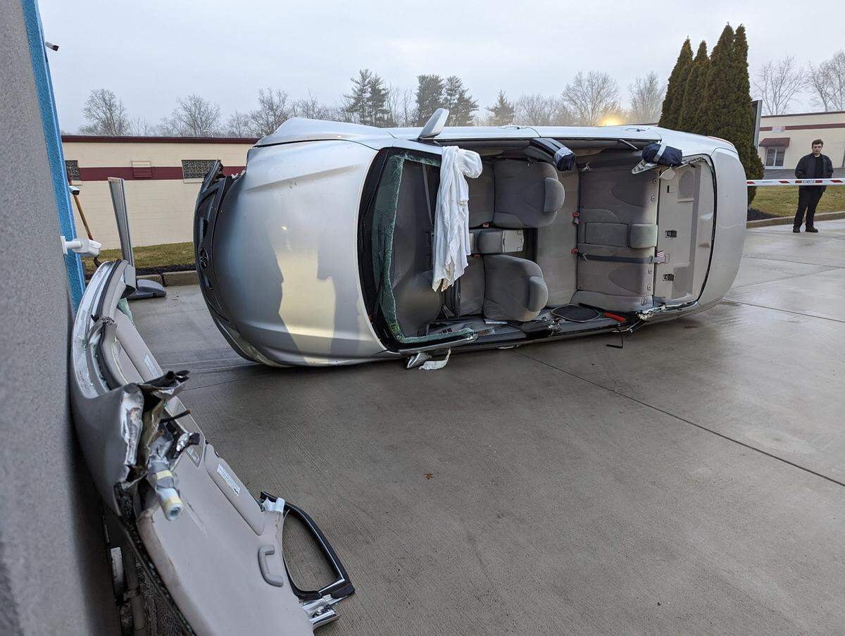 Firefighters used air bags, blocks and jacks to remove the car from the car wash, officials say.
