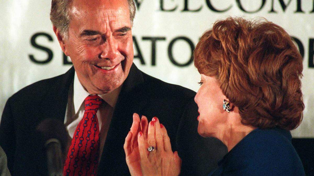Bob Dole looks with his wife, Elizabeth, after delivering a speech Tuesday, Oct. 29, 1996, to the World Affairs Council of Orange County in Irvine, Calif.