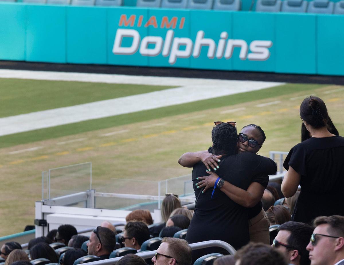 Two women hug while arriving before Jason Jenkins Celebration of Life on Monday, Sept. 5, 2022, at the Hard Rock Stadium in Miami Gardens. Jenkins was the Senior Vice President of Communications and Community Affairs for the Miami Dolphins.