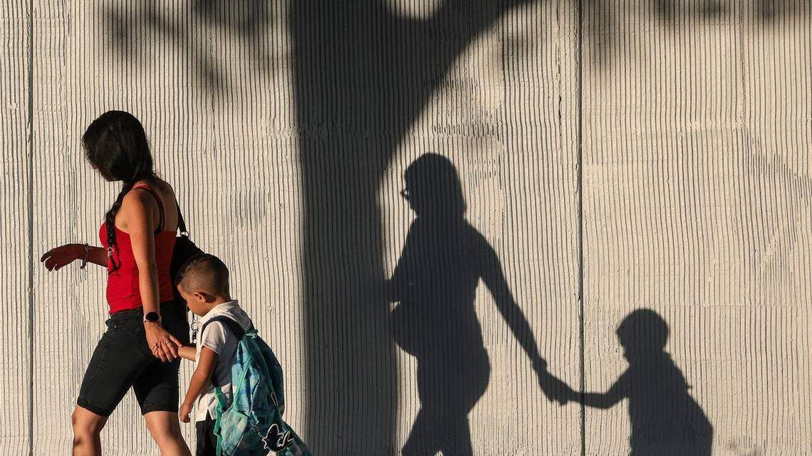 Yeiny Gonzalez walks with her son Ryland, who was beginning kindergarten in August 2022 at Miami Gardens Elementary School.