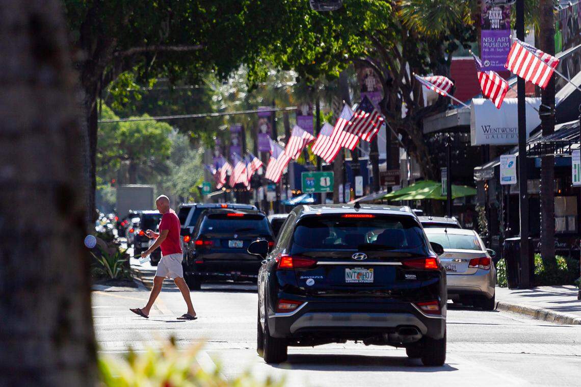 People make their way down East Las Olas Boulevard in Fort Lauderdale, Florida on Monday, April 26, 2021.