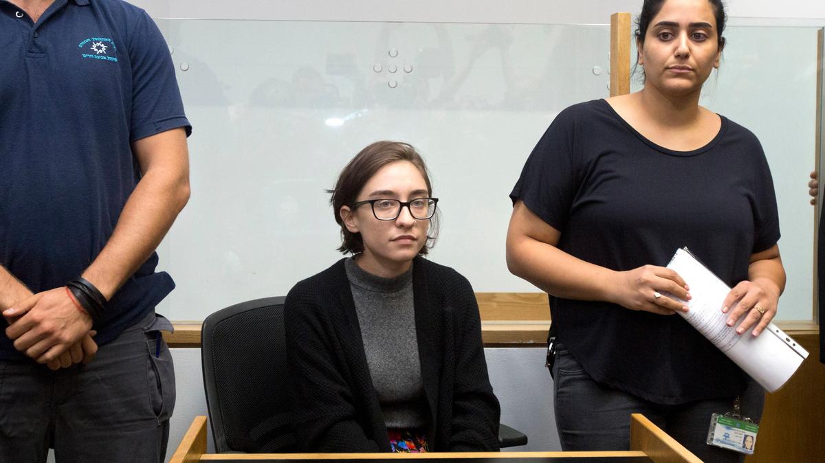 American Lara Alqasem, center, sits in a courtroom prior to a hearing at the district court in Tel Aviv, Israel, Thursday, Oct. 11, 2018. A senior Israeli cabinet minister on Wednesday defended the government’s handling of the case of Alqasem, a University of Florida graduate from Broward County who has been detained at the country’s international airport for the past week over allegations that she supports a boycott against the Jewish state.
