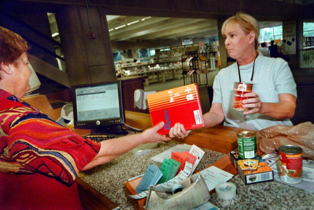 Broward County Libraries forgave library fines with a donation of canned food in this 2002 file photo.