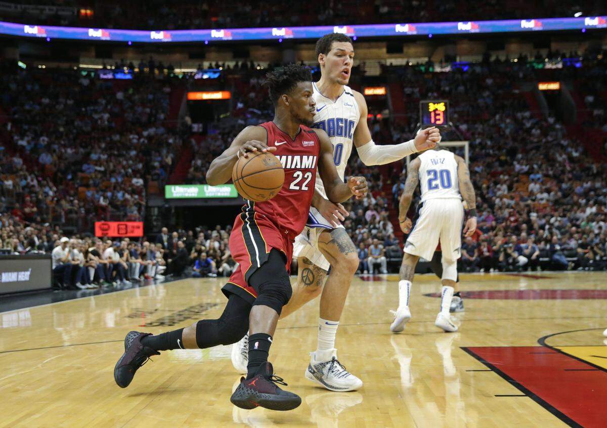 Miami Heat forward Jimmy Butler (22) drives against Orlando Magic guard Markelle Fultz (20) in the fourth quarter of an NBA basketball regular season game at the AmericanAirlines Arena on Wednesday, March 4, 2020.